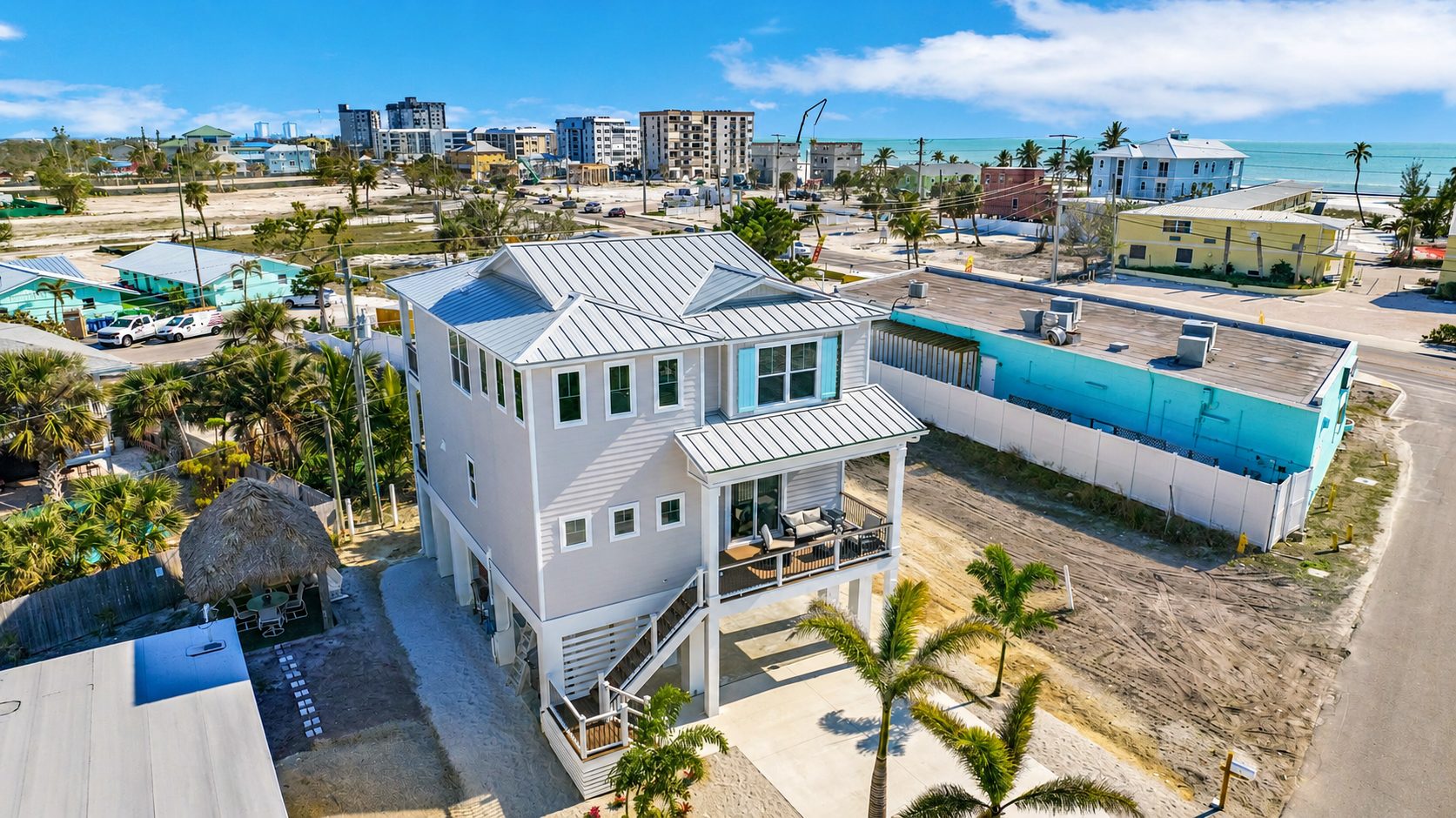 Aerial view of Do We Beach House, Fort Myers Beach vacation rental with Gulf in the background