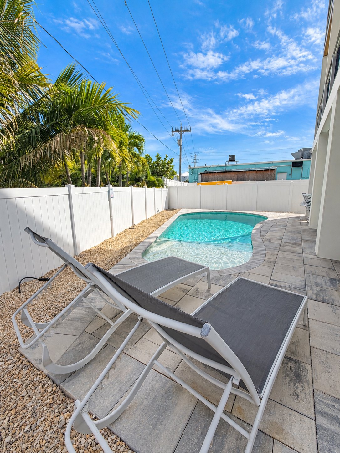 Two lounge chairs beside the private heated pool